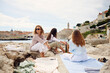 © Boris Jovanovic/Stocksy - Women hanging out the beach rocks