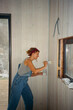 © Alina Hvostikova/Stocksy - LGBTQ woman painting interior wall during home repair project