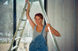 © Alina Hvostikova/Stocksy - LGBTQ builder repairs a home while showcasing skills and confidence