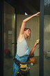 © Alina Hvostikova/Stocksy - Woman builder measuring window during construction in modern home