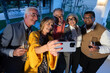 © VICTOR TORRES/Stocksy - Happy senior friends taking a selfie at an evening celebration