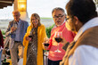 © VICTOR TORRES/Stocksy - Outdoor gathering with friends enjoying wine and conversation