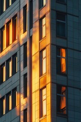 Poster - A tall building with windows lit up at sunset