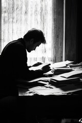 Poster - A person sits at a desk or table, writing on a piece of paper with pen and paper