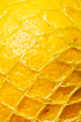 Close-Up of a Lemon in Yellow Mesh Packaging