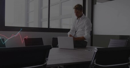 Poster - Adjusting sleeves, businessman sitting at conference table with laptop nearby