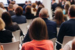 © tsuguliev - Audience at the modern conference hall listens to panel discussion, people on a congress together listen to speaker on stage at convention, plenary session at business seminar, venue for presentation