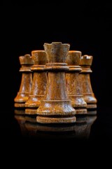 Poster - A set of wooden chess pieces arranged on a dark background, suitable for use in strategic planning or game-themed designs