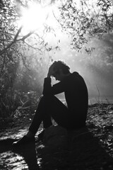 Poster - A person sitting on a rock in a scenic outdoor setting