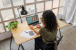 © BONNINSTUDIO/Stocksy - Woman working with laptop analyzing graphs at office