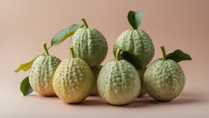 Poster - Fresh green guavas arranged in a cluster with green leaves on a soft pastel peach background showcasing their textured surface and natural beauty.