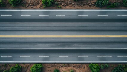 Poster - Aerial view of empty asphalt highway with white lane markings bordered by green vegetation on both sides and ample space for text or design.