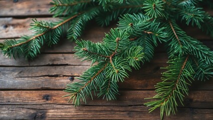 Leinwandbilder - Lush green pine branches arranged diagonally on a rustic wooden table background showcasing textures of wood and greenery in natural lighting