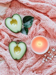 Poster - A cozy scene with a pink blanket, candle, and two ripe avocados set against a warm background