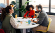 © VICTOR TORRES/Stocksy - Group podcast discussion in modern office setting