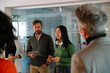 © VICTOR TORRES/Stocksy - Team discussion in modern office with diverse group