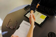 © BONNINSTUDIO/Stocksy - Business people shaking hands after signing creative brief contract