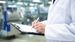 © MMSaddam - Quality Control Inspector in Food Processing Factory with Clipboard