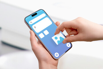 Poster - Close-up of hand holding smartphone, placing picture image box on app interface, concept of drag-and-drop UI design and mobile application development