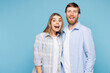 © ViDi Studio - Young shocked surprised fun couple two friends family man woman wear shirt casual clothes together look camera isolated on pastel plain light blue cyan background studio portrait. Lifestyle concept.