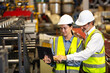 © NVB Stocker - Trainee. caucasian Factory worker training to  apprentice colleague on production line in Heavy Industry Manufacturing Facility. Instructor with Trainee working at factory