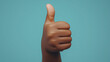 © Graceful - Hand giving thumbs up gesture on blue background, symbolizing positivity and approval