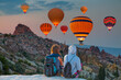 © muratart - Hot air balloon flying over spectacular Cappadocia -  Goreme, Turkey