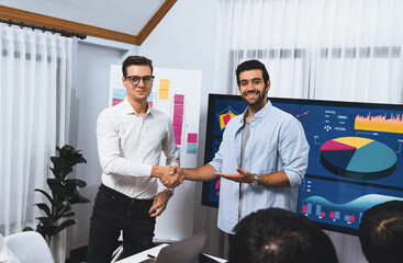 Leinwandbilder - Analyst team leader shake hand with his colleague after successful data analysis meeting using FIntech software power with business intelligence or BI dashboard. Prudent