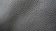© SerPak - Close-up of gray textured leather surface with detailed grain pattern.
