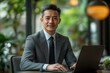 © MastersedZ - Professional man in suit working on laptop in modern office