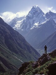 Leinwandbilder - Majestic snow-capped mountain range with hiker enjoying breathtaking valley view on a clear day