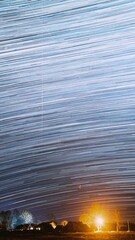 Wall Mural - Timelapse Night Starry Sky Above Village. Sky Background Over Rural Countryside Landscape. Meteors Cross Dark Blue Sky. Amazing Unusual Stars Effects. Bright Blue Colors. Time Lapse, Time-lapse