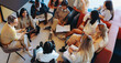 © Jacob Lund - College students gathering on campus in collaborative group study session with a diverse mix of young adults