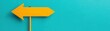 © nattapon98 - A bright yellow arrow sign points to the left against a vibrant teal background, creating a striking contrast and clear directional cue.