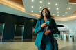 © Jacob Lund - Confident professional woman walking in modern corporate lobby