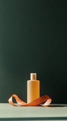Poster - elegant bottle with soft orange ribbon on a neutral background in natural light