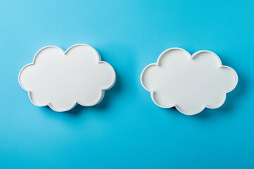 Poster - Two white cloud shapes on a bright blue background minimalist design concept sky art idea image color