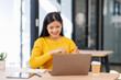 © David - Young confident asian woman using laptop at workplace office. online business work.