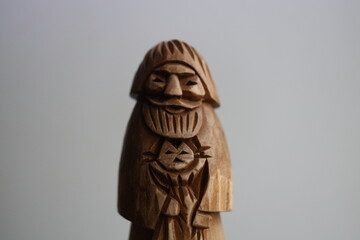 Poster - A wooden sculpture of a man holding a domestic cat, great for home decor or wildlife themed designs.