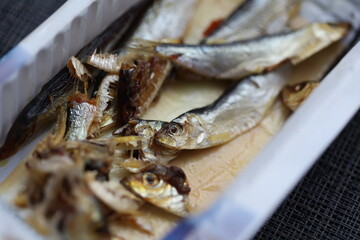Poster - A container filled with fish sitting on top of a table, great for food or decoration.