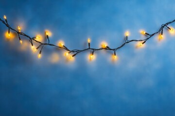 Poster - Festive garland of tiny glowing bulbs casting a soft warm light, creating a blurred, ethereal atmosphere on a deep blue canvas