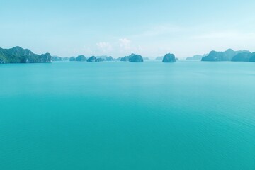 Poster - vibrant drone shot of ha long bay with limestone islands rising from emerald waters under bright sky