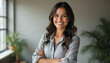 © miss irine - Smiling Latina businesswoman in office. Confident female pro in 30s 40s standing with crossed arms. Strong, experienced, successful entrepreneur. Leadership, empowerment, career themes. Modern,