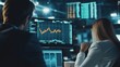 © kiki__ - Focused financial analysts examining stock market trends on monitors