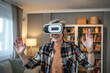 © Migma_Agency - Excited senior woman exploring virtual reality at home