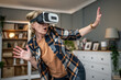 © Migma_Agency - Amazed mature woman wearing vr headset interacting with virtual reality at home