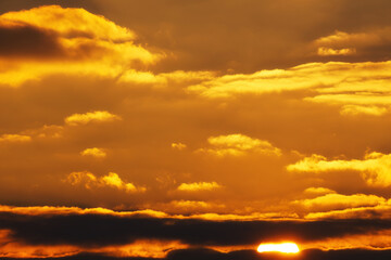 Wall Mural - beautiful and dramatic sunset sky with bright yellow clouds as abstract background