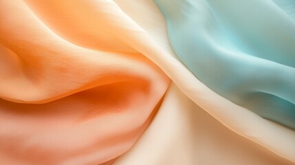 Poster - colorful silk fabric draping in shades of orange, cream, and light blue creating an elegant texture 
