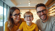 © miss irine - Happy family of three in optical store smiling, wearing new stylish glasses. Parents with son choose eyeglasses. Eye health checkup, vision care, optometry for kids and adults. Eyewear fashion.