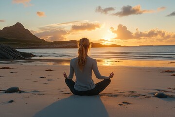 Poster - Meditation at sunset on a tranquil beach with gentle waves lapping the shore and mountains silhouetted against the glowing sky